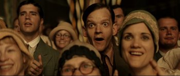 Movie still from “O Brother, Where Art Thou?” (2000), directed by Joel Coen – A group of people that are standing in a room; Close Up shot, Low angle