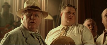 Movie still from “O Brother, Where Art Thou?” (2000), directed by Joel Coen – Two men in hats and a tie looking at each other; Close Up shot, Low angle