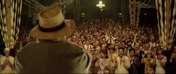 Movie still from “O Brother, Where Art Thou?” (2000), directed by Joel Coen – A large group of people wearing hats in front of a crowd; Wide shot, Low angle