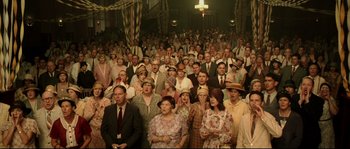 Movie still from “O Brother, Where Art Thou?” (2000), directed by Joel Coen – A large group of people are gathered in a room; Wide shot, High angle