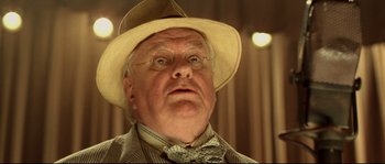 Movie still from “O Brother, Where Art Thou?” (2000), directed by Joel Coen – An older man wearing a hat and a tie; Close Up shot, Low angle