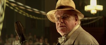 Movie still from “O Brother, Where Art Thou?” (2000), directed by Joel Coen – An older man wearing a hat and a tie; Close Up shot, Low angle