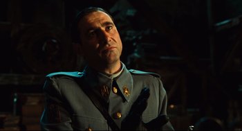 Movie still from “Pan's Labyrinth” (2006), directed by Guillermo del Toro – A man in a military uniform holding a gun; Close Up shot, Low angle