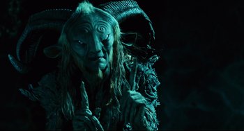 Movie still from “Pan's Labyrinth” (2006), directed by Guillermo del Toro – A man with a long hair and a mask on his face; Close Up shot, Overhead angle