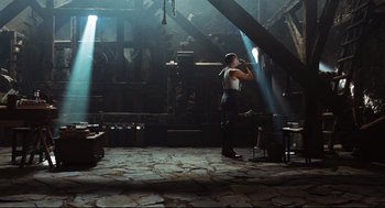 Movie still from “Pan's Labyrinth” (2006), directed by Guillermo del Toro – A man standing in the middle of a room with light shining on him; Wide shot, Low angle