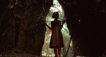 Movie still from “Pan's Labyrinth” (2006), directed by Guillermo del Toro – A woman standing in the woods near a tree; Wide shot, Low angle
