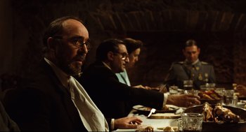 Movie still from “Pan's Labyrinth” (2006), directed by Guillermo del Toro – A group of people sitting at a dinner table; Medium shot, Over the shoulder angle