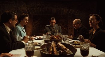 Movie still from “Pan's Labyrinth” (2006), directed by Guillermo del Toro – A group of people sitting around a table with food; Wide shot, High angle