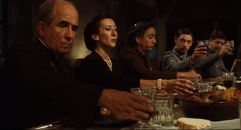 Movie still from “Pan's Labyrinth” (2006), directed by Guillermo del Toro – A group of people sitting at a dinner table; Medium shot, Low angle