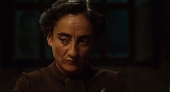 Movie still from “Pan's Labyrinth” (2006), directed by Guillermo del Toro – An older woman is looking down at the camera; Close Up shot, Low angle