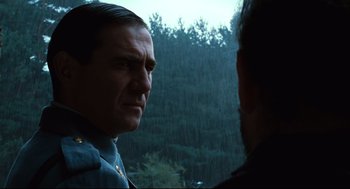 Movie still from “Pan's Labyrinth” (2006), directed by Guillermo del Toro – A man in a police uniform looking at another man in a forest; Close Up shot, Over the shoulder angle