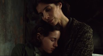Movie still from “Pan's Labyrinth” (2006), directed by Guillermo del Toro – A woman and a child are snuggled together; Close Up shot, High angle