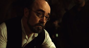 Movie still from “Pan's Labyrinth” (2006), directed by Guillermo del Toro – A person wearing glasses and a beard; Close Up shot, Over the shoulder angle