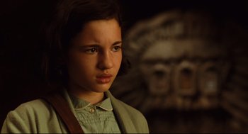 Movie still from “Pan's Labyrinth” (2006), directed by Guillermo del Toro – A young girl is looking into the camera; Close Up shot, High angle