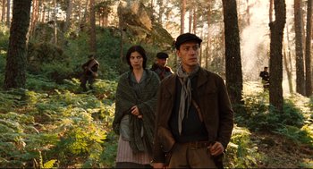 Movie still from “Pan's Labyrinth” (2006), directed by Guillermo del Toro – A group of people walking through a forest; Medium shot, Low angle