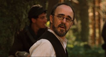 Movie still from “Pan's Labyrinth” (2006), directed by Guillermo del Toro – A man with a beard wearing glasses and a vest; Close Up shot, Over the shoulder angle