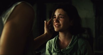 Movie still from “Pan's Labyrinth” (2006), directed by Guillermo del Toro – A girl is crying while being touched by a hand; Close Up shot, Over the shoulder angle