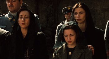 Movie still from “Pan's Labyrinth” (2006), directed by Guillermo del Toro – A group of people standing next to each other; Medium shot, Low angle