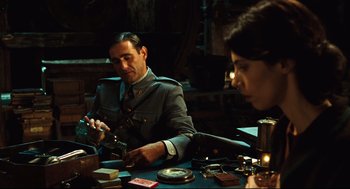 Movie still from “Pan's Labyrinth” (2006), directed by Guillermo del Toro – A man and a woman sitting at a table; Medium shot, Over the shoulder angle