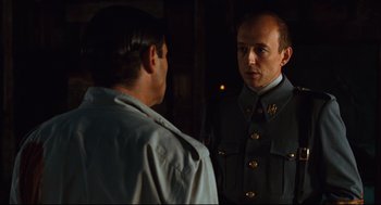 Movie still from “Pan's Labyrinth” (2006), directed by Guillermo del Toro – A man in a uniform talking to another man in a uniform; Close Up shot, Over the shoulder angle