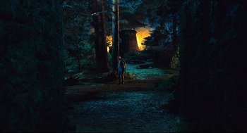Movie still from “Pan's Labyrinth” (2006), directed by Guillermo del Toro – A man standing next to a tree in the dark; Extreme Wide shot, High angle