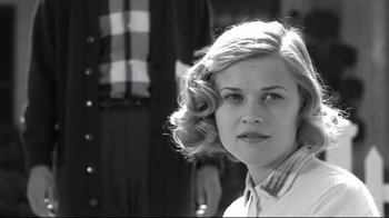 Movie still from “Pleasantville” (1998), directed by Gary Ross – A black and white photo of a woman with a hair roller; Close Up shot, Low angle