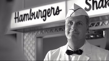 Movie still from “Pleasantville” (1998), directed by Gary Ross – A man wearing a white hat and a tie; Close Up shot, Low angle