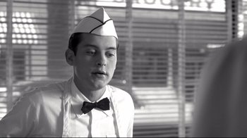 Movie still from “Pleasantville” (1998), directed by Gary Ross – A young man wearing a sailor's hat and a bow tie; Close Up shot, Over the shoulder angle