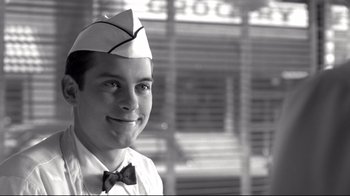 Movie still from “Pleasantville” (1998), directed by Gary Ross – A man wearing a sailor's hat and a bow tie; Close Up shot, Low angle