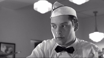 Movie still from “Pleasantville” (1998), directed by Gary Ross – A man wearing a bow tie and a sailor's hat; Close Up shot, Low angle