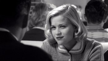 Movie still from “Pleasantville” (1998), directed by Gary Ross – A black - and - white photo of a woman with blonde hair; Close Up shot, Over the shoulder angle