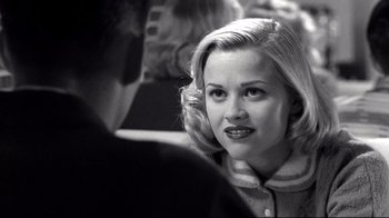Movie still from “Pleasantville” (1998), directed by Gary Ross – A black - and - white photo of a woman in a sweater; Close Up shot, Over the shoulder angle