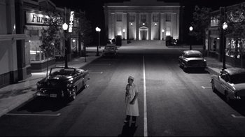Movie still from “Pleasantville” (1998), directed by Gary Ross – A man standing in the middle of the street at night; Extreme Wide shot, Low angle