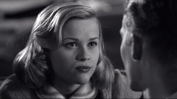 Movie still from “Pleasantville” (1998), directed by Gary Ross – A black - and - white photo of a woman and a man; Close Up shot, Over the shoulder angle