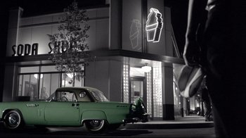 Movie still from “Pleasantville” (1998), directed by Gary Ross – An old car parked on the side of the street; Wide shot, High angle