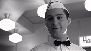 Movie still from “Pleasantville” (1998), directed by Gary Ross – A young man wearing a hat and a bow tie; Close Up shot, Low angle