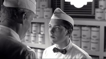 Movie still from “Pleasantville” (1998), directed by Gary Ross – A young man wearing a sailor's hat talking to another young man; Close Up shot, Over the shoulder angle