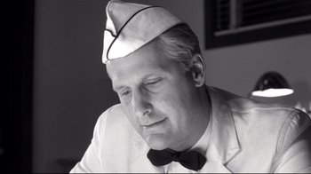 Movie still from “Pleasantville” (1998), directed by Gary Ross – An older man wearing a sailor's hat and bow tie; Close Up shot, Low angle