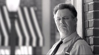 Movie still from “Pleasantville” (1998), directed by Gary Ross – Black and white photograph of a man in a tie; Close Up shot, Low angle