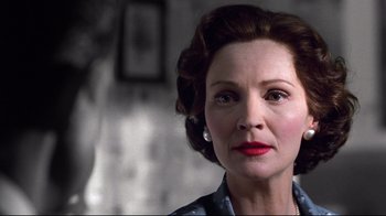 Movie still from “Pleasantville” (1998), directed by Gary Ross – An older woman wearing a blue shirt and red lipstick; Close Up shot, Low angle