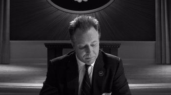 Movie still from “Pleasantville” (1998), directed by Gary Ross – Black and white photograph of a man in a suit and tie; Close Up shot, High angle