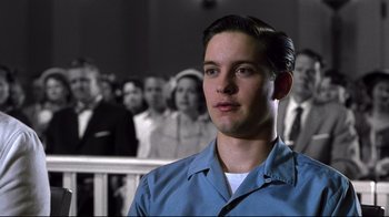 Movie still from “Pleasantville” (1998), directed by Gary Ross – A man in a blue shirt is in front of a group of people; Close Up shot, Low angle