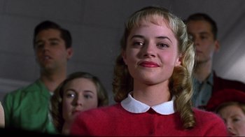 Movie still from “Pleasantville” (1998), directed by Gary Ross – A woman with blonde hair and a red shirt; Close Up shot, Low angle