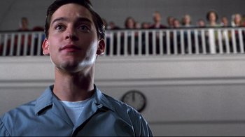 Movie still from “Pleasantville” (1998), directed by Gary Ross – A man standing in front of a crowd of onlookers; Close Up shot, Low angle