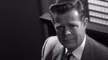 Movie still from “Pleasantville” (1998), directed by Gary Ross – An older man wearing a suit and tie; Close Up shot, Over the shoulder angle