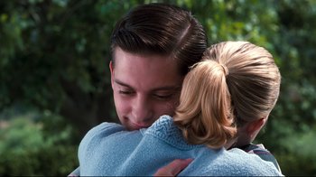 Movie still from “Pleasantville” (1998), directed by Gary Ross – A man and a woman hugging each other outside; Close Up shot, Over the shoulder angle
