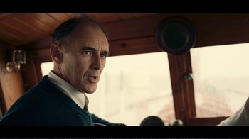 Movie still from “Dunkirk” (2017), directed by Christopher Nolan – A person in a vehicle; Close Up shot, Over the shoulder angle