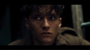 Movie still from “Dunkirk” (2017), directed by Christopher Nolan – A young man's face in the dark; Close Up shot, Low angle
