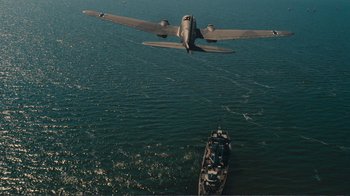 Movie still from “Dunkirk” (2017), directed by Christopher Nolan – An airplane flying over a boat in the ocean; Extreme Wide shot, High angle