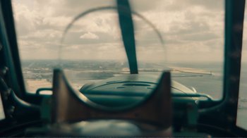 Movie still from “Dunkirk” (2017), directed by Christopher Nolan – A view from inside an airplane looking out of the window; Extreme Close Up shot, High angle